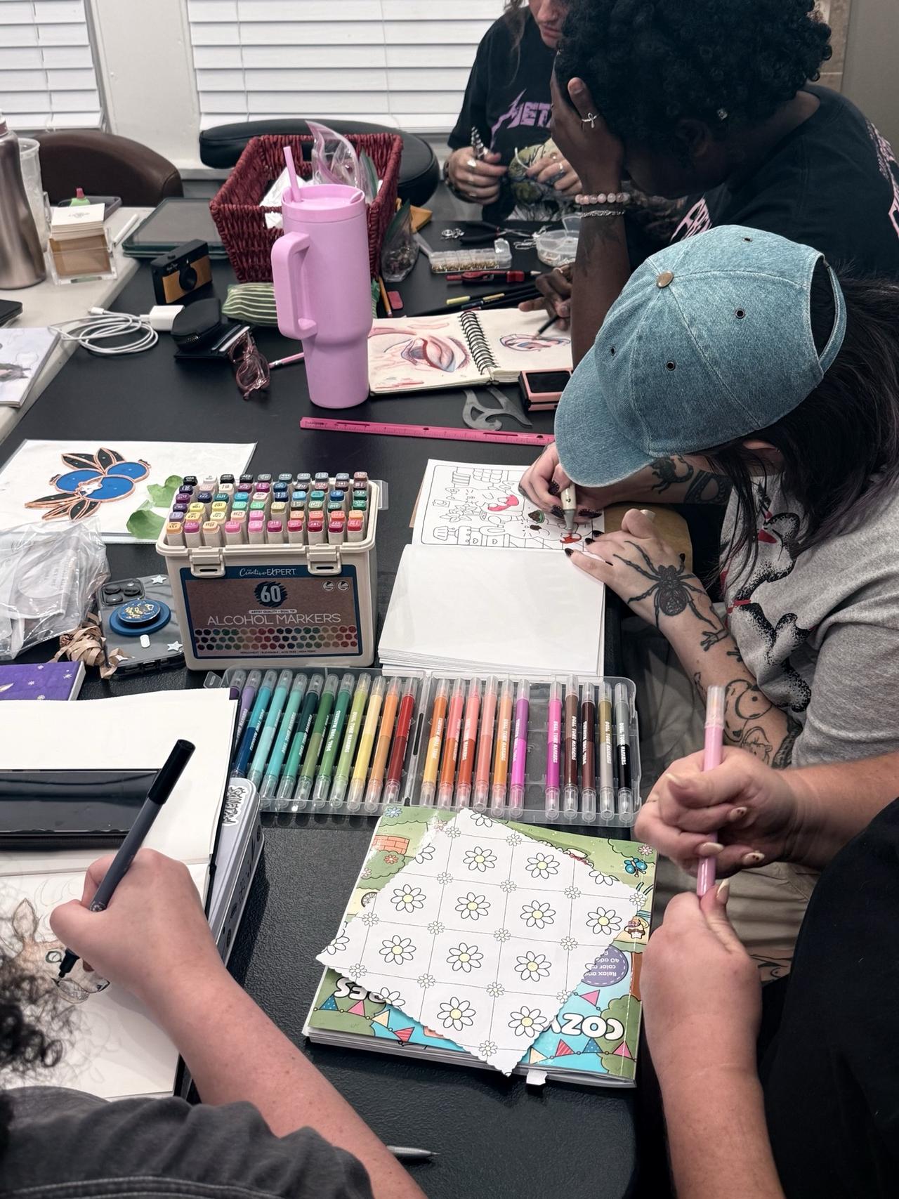 Artists sharing a creative workspace during a workshop