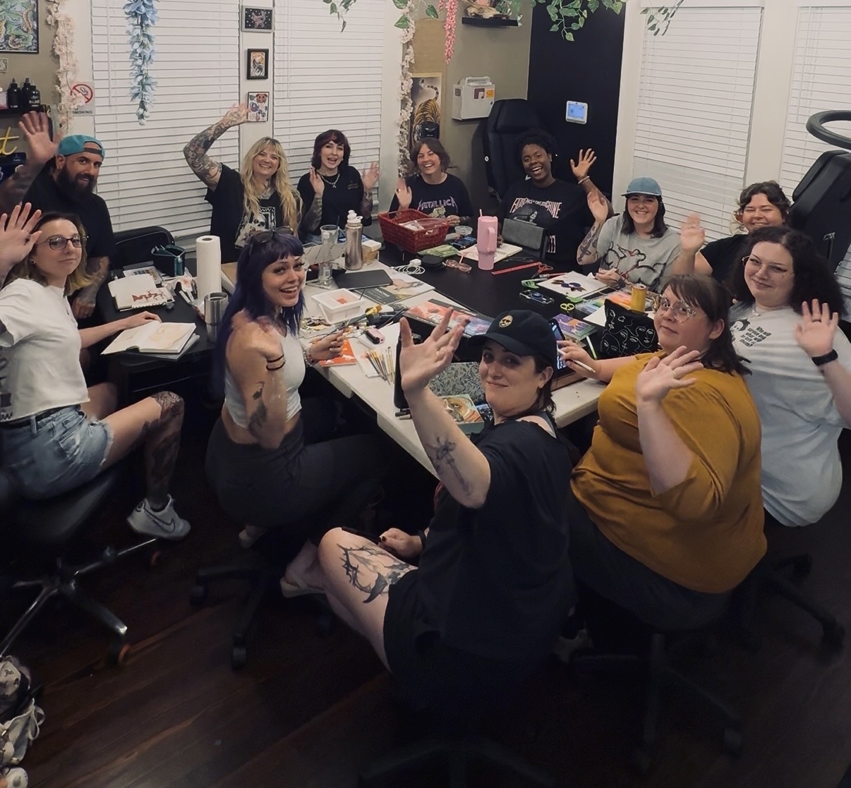 A group of artists gathered around a table at a creative workshop